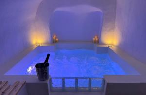 a blue tub with a bottle of wine in it at Loveroom La Cesarine Jacuzzi privé in Mougins