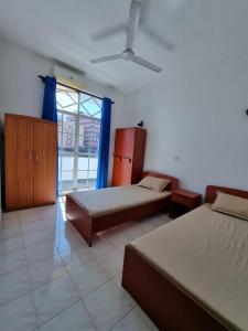 a bedroom with two beds and a large window at Apartment in Colombo in Colombo