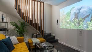 a living room with an elephant painting on the wall at Work & Travel _ EcoStay _ Środa Wielkopolska in Środa Wielkopolska
