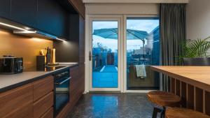 a kitchen with a view of a balcony with an umbrella at Work & Travel _ EcoStay _ Środa Wielkopolska in Środa Wielkopolska