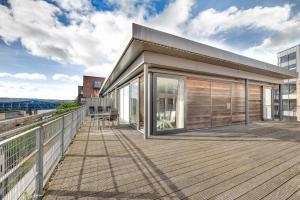 a house with a large deck with glass doors at Amazing City Centre Penthouse With Private Roof Terrace in Newcastle upon Tyne
