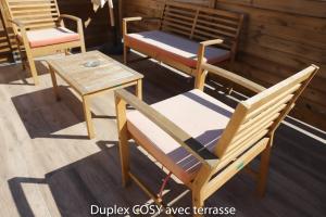 a group of chairs and a table on a porch at Duplex cosy avec terrasse in Marseille