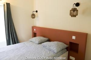 a bedroom with a bed with two pillows on it at Duplex cosy avec terrasse in Marseille