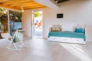 a bedroom with a bed and a chair in it at Casita Gopal in Icod de los Vinos