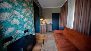 a living room with a couch and a kitchen at Anbani Apartments - City Center in Tbilisi City