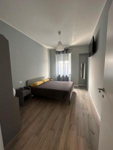 a bedroom with a bed and a wooden floor at La terrazza sullo Stadio in Venaria Reale