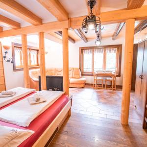 a bedroom with two beds and a dining room at Vila Triglav on Pokljuka in Goreljek