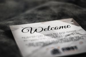 a piece of paper with the word welcome on it at Boutique Hotel First City in The Hague