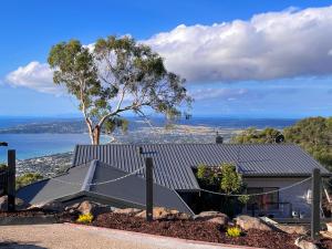 a house with a tree on top of it at Arthurs Holiday Villa in Arthurs Seat