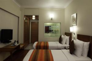 Postel nebo postele na pokoji v ubytování Regency Hotel