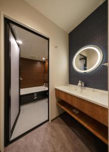 a bathroom with a sink and a mirror at HOTEL SAILS in Osaka +37 photos