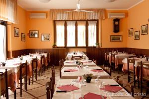 a dining room with long tables and chairs at Affittacamere Trattoria Del Cristo in Ospedaletto Lodigiano