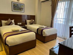 Ένα ή περισσότερα κρεβάτια σε δωμάτιο στο Hotel New Era