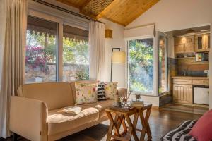a living room with a couch and a table at StayVista at Dudly Manor with Swimming Pool in Dehradun