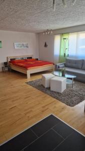 ein Wohnzimmer mit einem Bett und einem Sofa in der Unterkunft Jurastei14 in Wiedlisbach