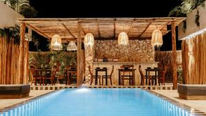 a resort with a swimming pool and a bar at Majaro Tulum in Tulum +54 photos