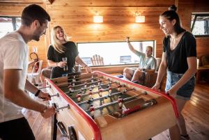 a group of people playing a game of billiard at Village Huttopia Sud Ardèche in Vagnas