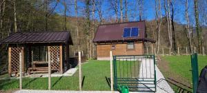 a small house with a solar panel on the roof at Apartma Kačwa in Kobarid