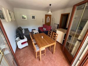 a living room with a wooden table and a couch at Apartamento Lagos Azules II in Ruilobuca