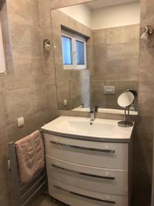 a bathroom with a sink and a mirror at Villa Mimy in Ugljan +29 photos