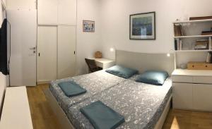 a bedroom with a bed with blue pillows on it at Villa Mimy in Ugljan