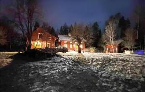 a house at night with snow on the ground at 1 Bedroom Stunning Home In Sala in Sala