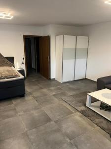 a living room with a bed and a tiled floor at Ferienwohnung Emilia in Cologne
