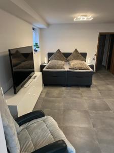 a bedroom with two beds and a couch in it at Ferienwohnung Emilia in Cologne