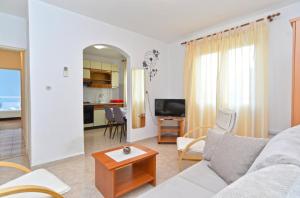 a living room with a couch and a table at Apartments Pietro 2228 in Bale