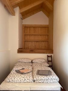 a bedroom with a bed with a wooden headboard at Apartmány Podhorie, Banská Štiavnica in Banská Štiavnica