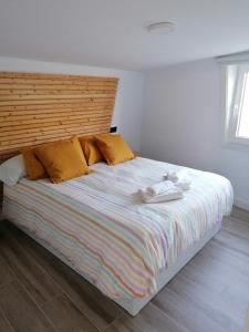 a bedroom with a large bed with towels on it at La Veiga Romana in Tui