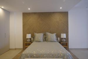 a bedroom with a large bed with two lamps at Rooms & Suites Loft 2F Deluxe Edition Arrecife in Arrecife