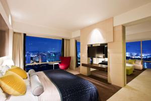 a hotel room with a bed and a large window at Ramada Plaza by Wyndham Suwon in Suwon