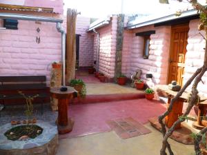 a courtyard of a house with a fire pit at Hostal La Soñada in Humahuaca