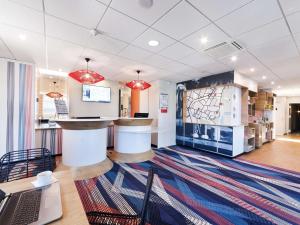 a lobby of a store with a counter and chairs at ibis Styles Toulouse Lavaur in Lavaur