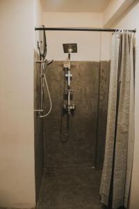 a shower in a bathroom with a shower curtain at Ollie resort in Ella