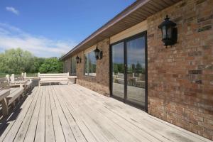 a wooden deck with benches and a brick building at Baymont by Wyndham Manistee in Manistee