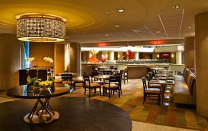 a restaurant with tables and chairs and a bar at Hyatt Regency Crystal City at Reagan National Airport in Arlington