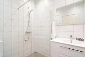 a white bathroom with a shower and a sink at Great Apt · Near Beach · CPH in Copenhagen