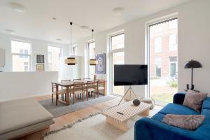 a living room with a blue couch and a table at Great Apt · Near Beach · CPH in Copenhagen +36 photos