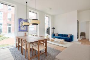 a living room with a table and a blue couch at Great Apt · Near Beach · CPH in Copenhagen