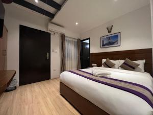 Ένα ή περισσότερα κρεβάτια σε δωμάτιο στο Hotel New Era