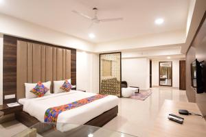 a bedroom with a large bed and a living room at The Xen Suites, Kolkata Airport in Kolkata