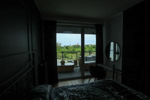 a bedroom with a bed and a view of a balcony at Apartament Gdynia Arena in Gdynia