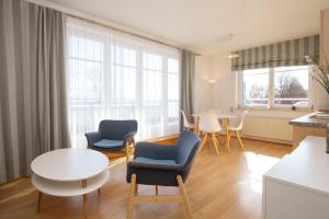 a living room with chairs and a table at Dünenblick Wohnung 17 in Boltenhagen