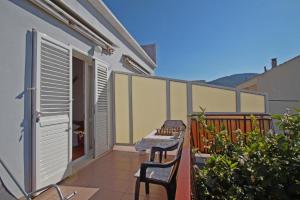 d'une terrasse avec 2 chaises et une table sur un balcon. dans l'établissement Apartman Bačić, à Vela Luka