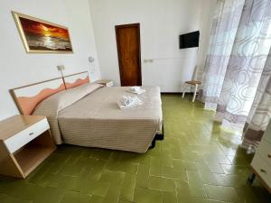 a bedroom with a bed and a table and a television at Bed&Breakfast Villa Lorena in Forte dei Marmi
