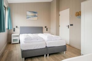 Ένα ή περισσότερα κρεβάτια σε δωμάτιο στο Vakantiehuis Zonnig Zuid - Julianadorp aan Zee
