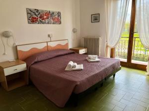 a bedroom with a bed with shoes on it at Bed&Breakfast Villa Lorena in Forte dei Marmi