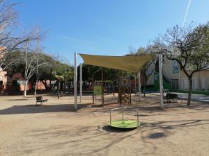 a playground with a tent and a swing set at Piso pl 2A, 20 min Plaza Cataluña in Sant Adria de Besos